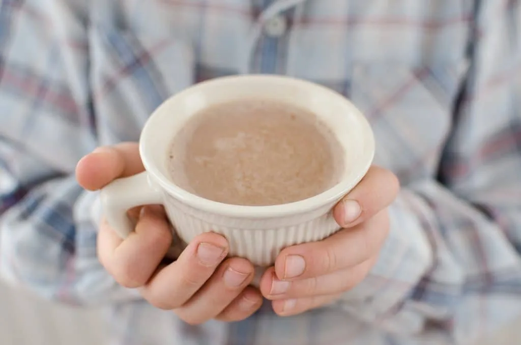 Hot Chocolate in a cup in a hand holding