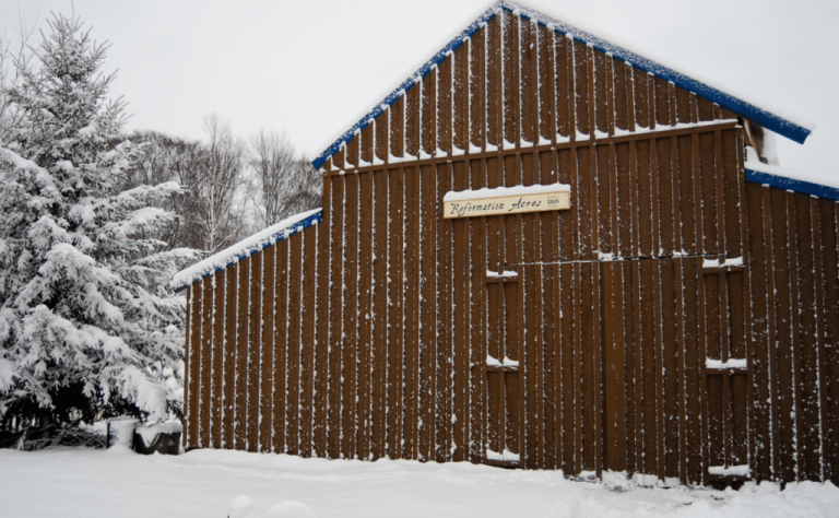 Barn brown with snow on it reformation acres