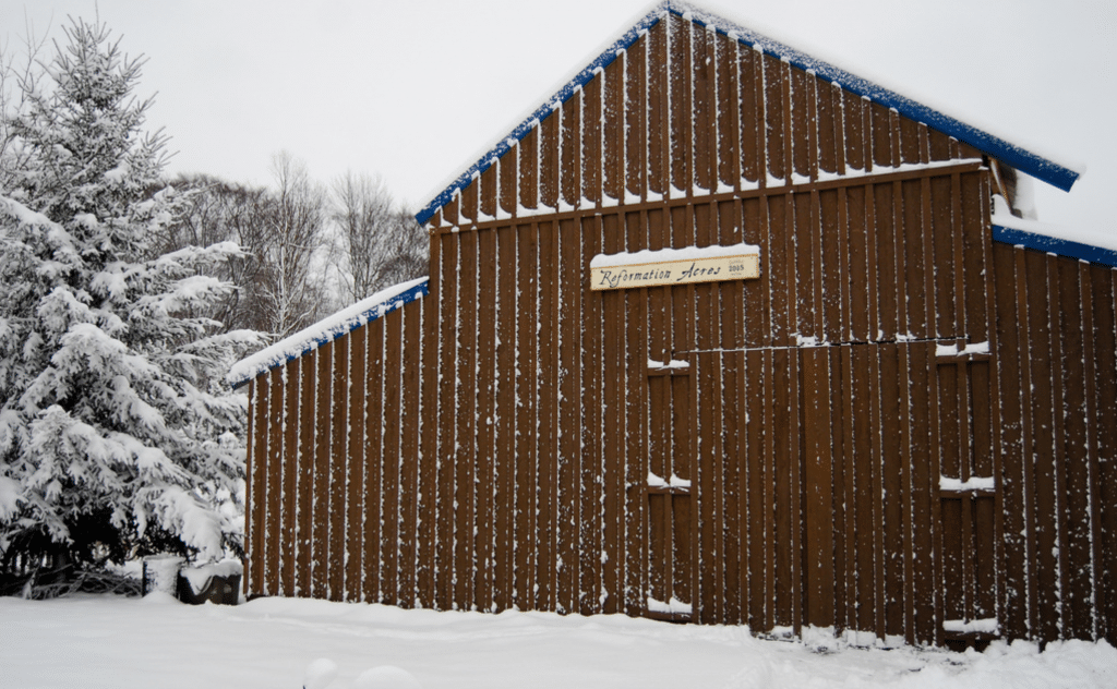 Barn brown with snow on it reformation acres