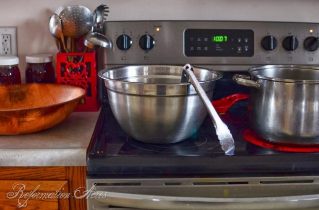 Stainless pots on a kitchen stove