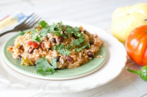 Spanish-Rice-2.jpg on a green plate on table