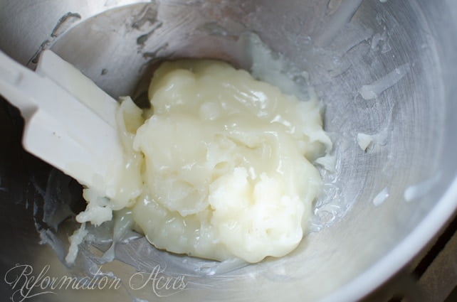 Putting the udder butter into a stainless bucket