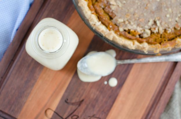 A jar of condensed milk beside a pie