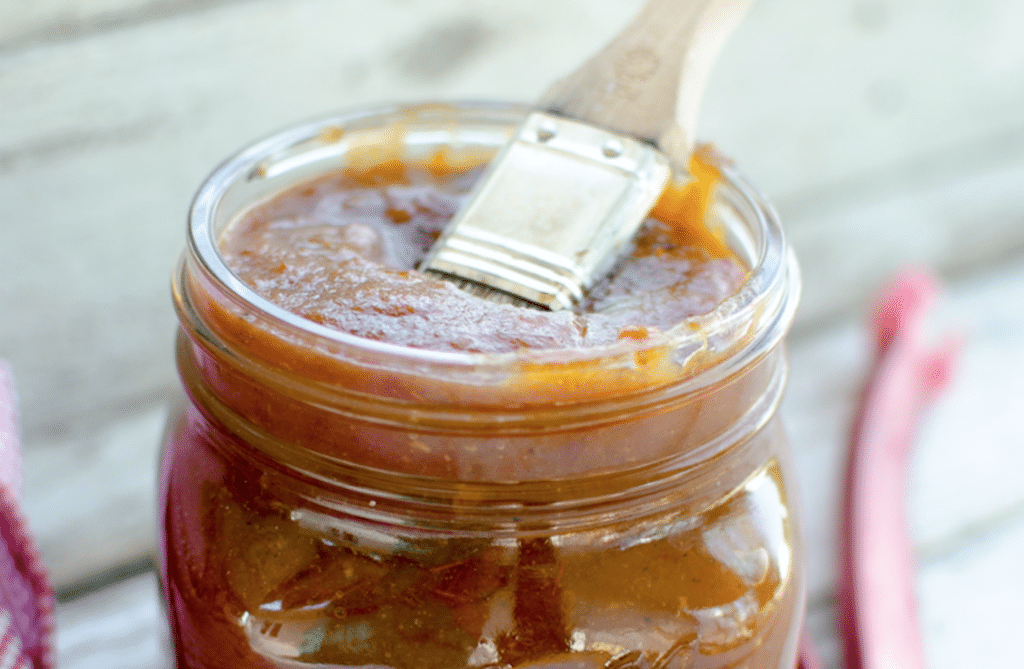 sauce in glass jar with brush