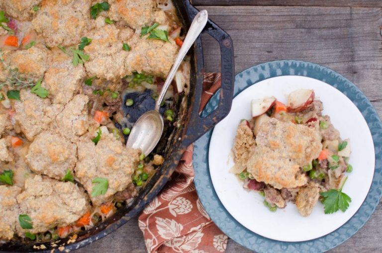 beef pot pie piece on white plate with spoon