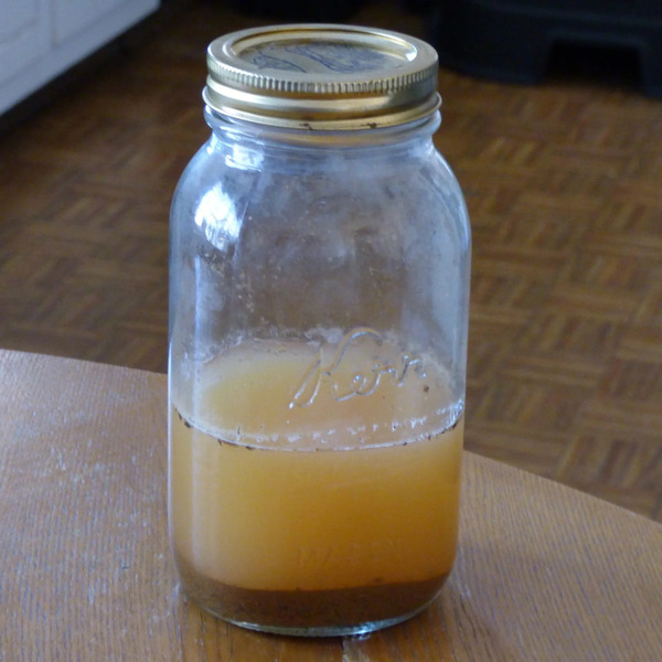 mason jar with water and soil on top of the table