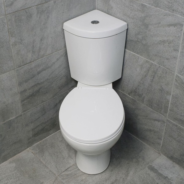 toilet bowl at the edge of the corner