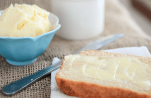 slice of bread with butter notable next to knife