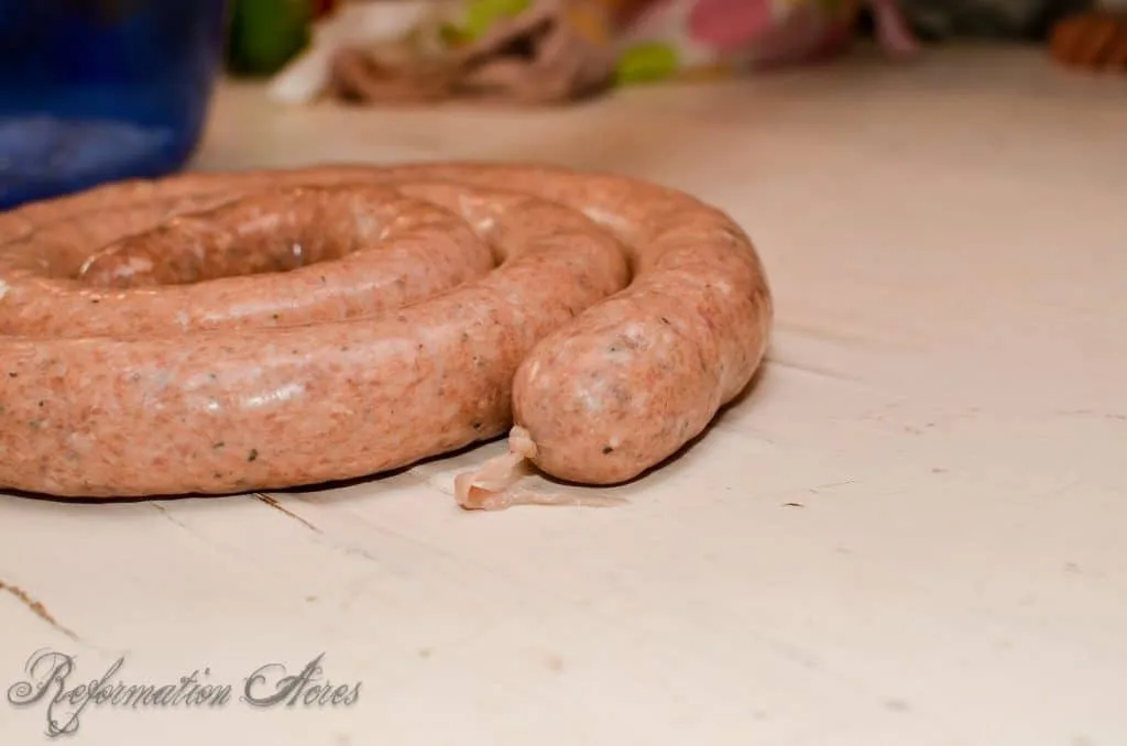 sausage and casing roll on wooden board