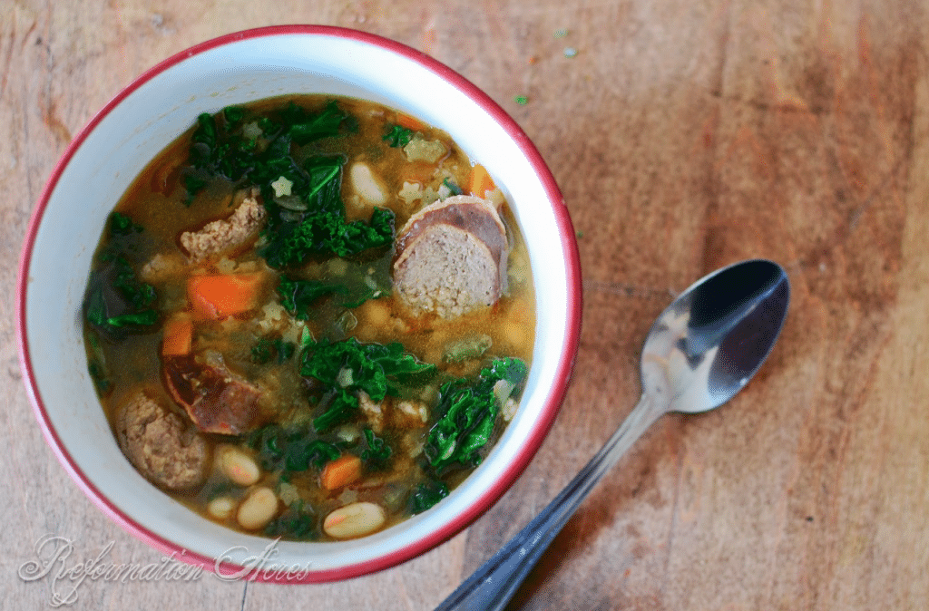 bowl of soup with spoon next to it kielbasa soup