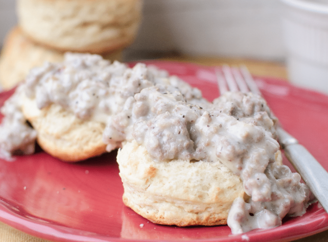 Sausage Gravy & Biscuits on red plate
